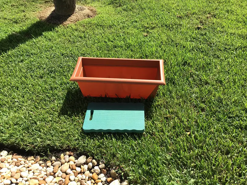 Kneeling Pad And Long Container Pot In Grass