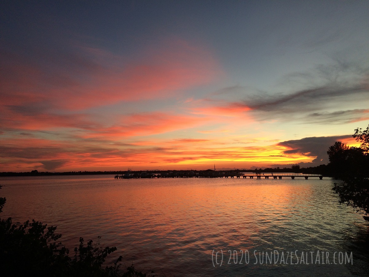 Stunning Sunset Over Dock With Coral Ripples On Water