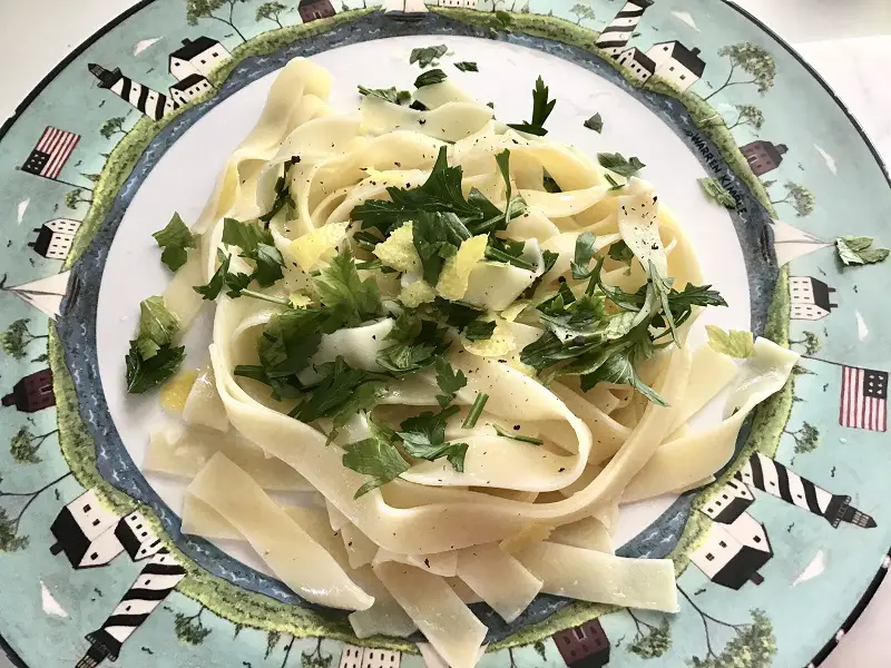 Easiest Summer Pasta Dish With Fresh Parsley And Lemon Zest. Grown-Up Noodles With Butter On A Nautical Themed Plate