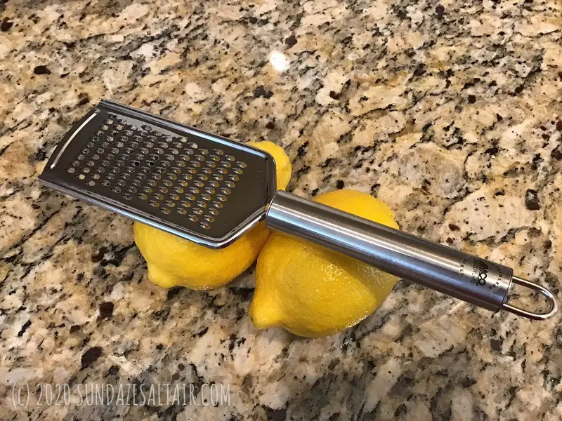 Lemons With Zester On Granite Countertop