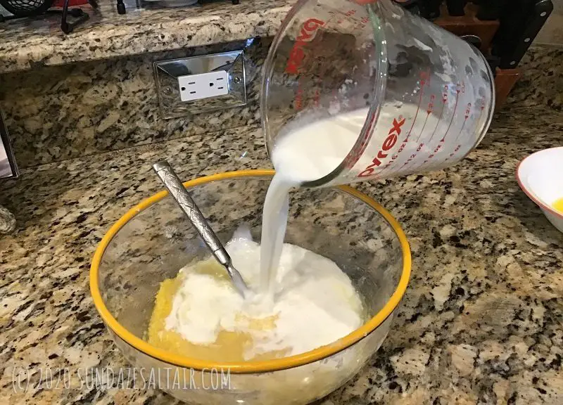Pouring Milk Into Lemon Pudding Cake Custard Batter