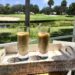 Watercress And Zucchini Soup With Smoked Paprika And Chives In Glasses On Tray Overlooking The Water