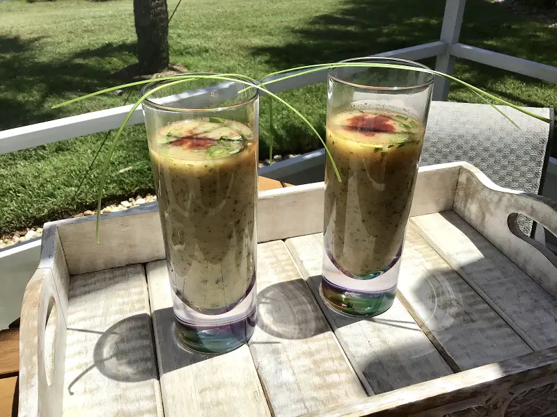 Watercress And Zucchini Soup With Smoked Paprika And Chives On A Tray Outside Al Fresco