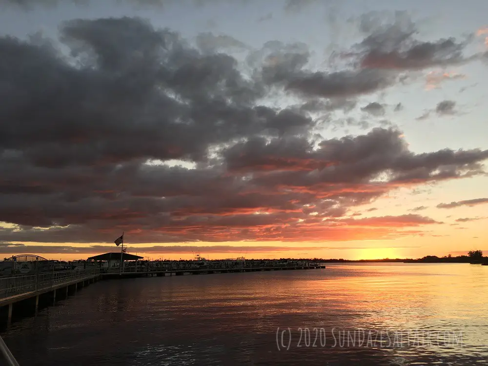 Autumn Sunset Behind Spooky Stormy Clouds Hanging Over Dock And Bay