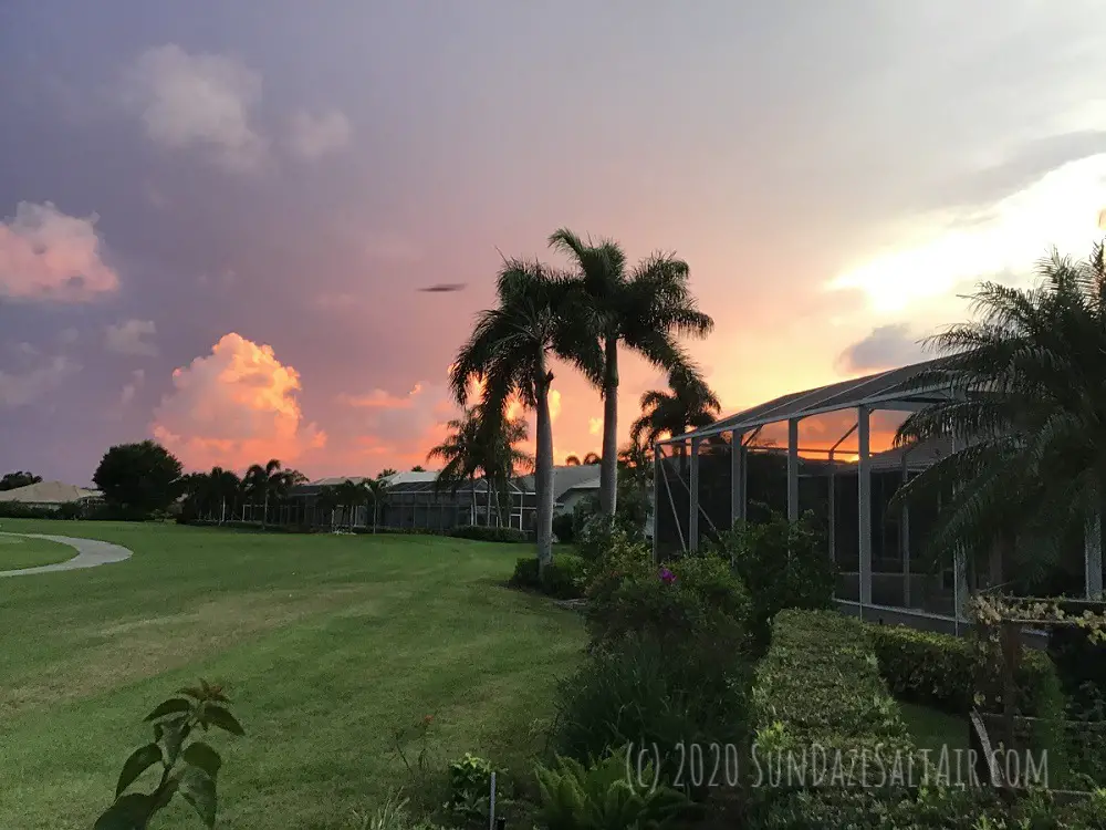 Beautiful Lavender And Coral Skies After A Storm With Palm Trees And A Scenic Vista