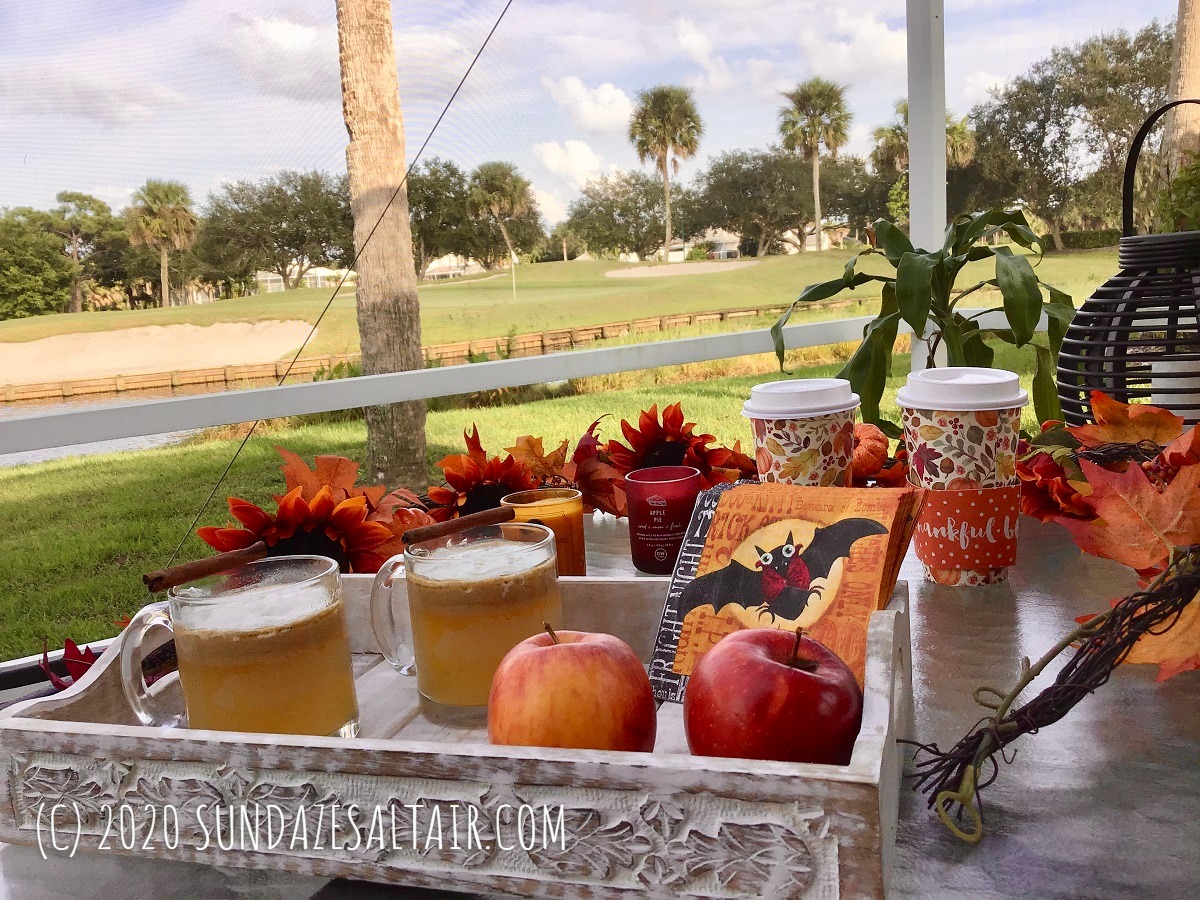 Easy, Delicious Homemade Hot Spiced Caramel Apple Cider Like Starbucks In Glass Mugs Surrounded By Beautiful Lake And Fall Decor