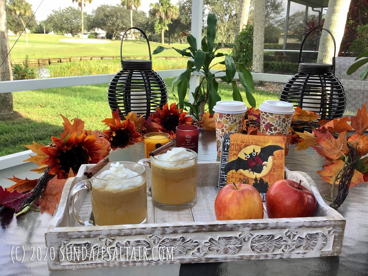 Easy, Delicious Homemade Hot Spiced Caramel Apple Cider Like Starbucks In Glass Mugs Surrounded By Beautiful Lake And Fall Garland, Candles & Apples