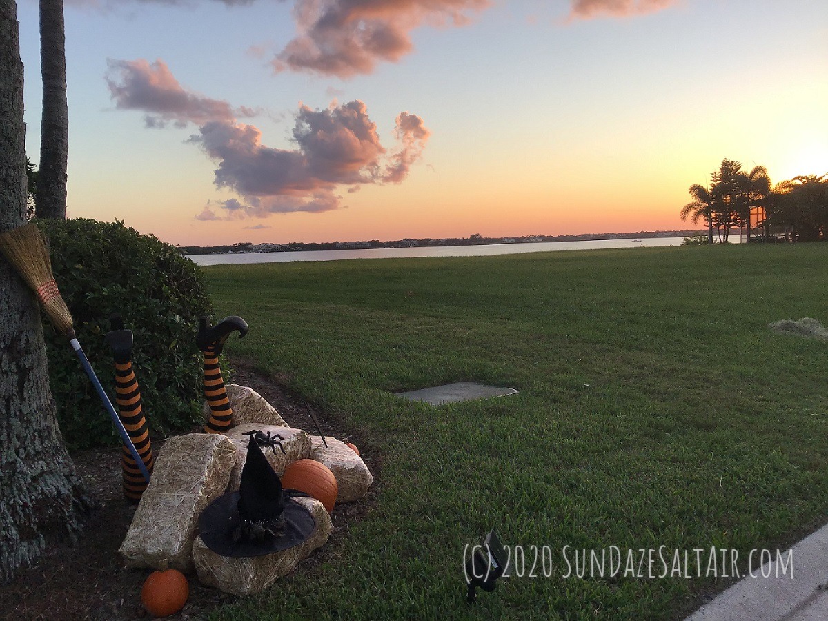 Witch Crash Landed Halloween Decoration In Front Of Palm Trees And Beautiful Twilight Sunset Sky Overlooking Water Views