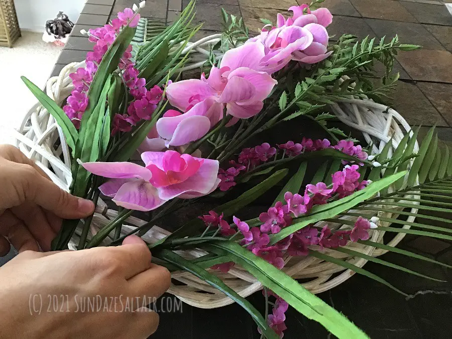 How to make a tropical wreath - experiment with different tropical greenery & flowers before using any glue to transform an old wreath into a tropical wreath