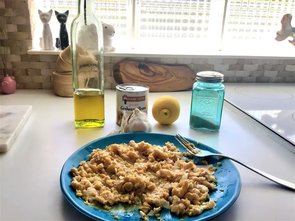 Preparing easiest, best hummus without tahini with lemon, garlic, olive oil, sea salt and another secret ingredient