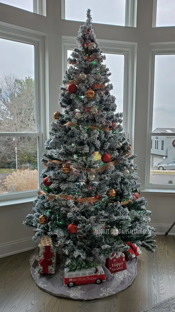 How To Decorate A Room With High Ceilings For Christmas-Choose a large tree to be the focal point of your living room & place it in front of large windows to highlight the tree & the view