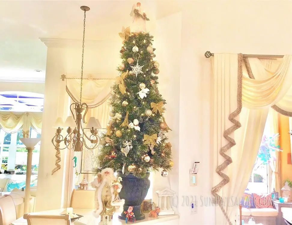 How To Decorate A Room With High Ceilings For Christmas-Place smaller trees on tables & ledges to fill up empty spots with Christmas spirit