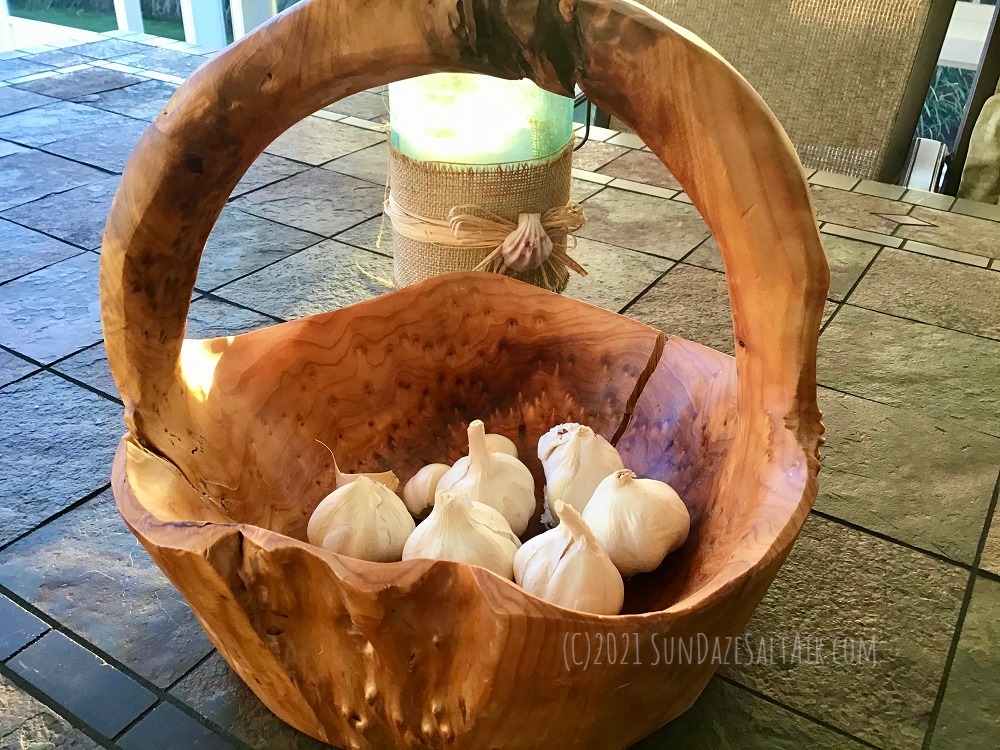 How To Grow Your Own Garlic This Winter For Amazing Flavor & Health Benefits-Garlic bulbs in rustic wood basket on table