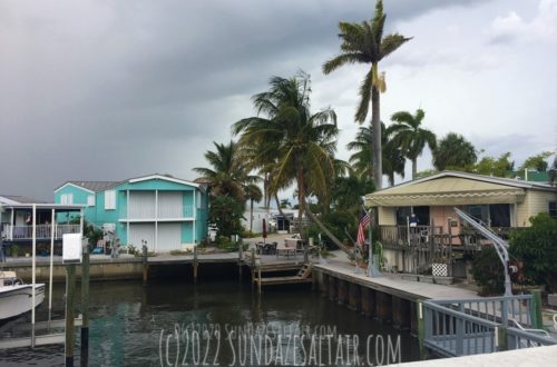 How to Save Money On Your Homeowners Insurance_How I Saved Over $1,000 In This Crazy Market_Storm clouds over beach houses