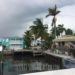 How to Save Money On Your Homeowners Insurance_How I Saved Over $1,000 In This Crazy Market_Storm clouds over beach houses