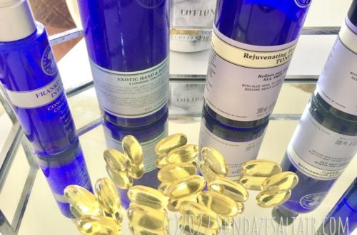 How to Repair the Skin Lipid Barrier Naturally with Evening Primrose Oil capsules on glass & silver tray surrounded by blue bottles