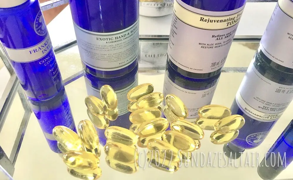 How to Repair the Skin Lipid Barrier Naturally with Evening Primrose Oil capsules on glass & silver tray surrounded by blue bottles